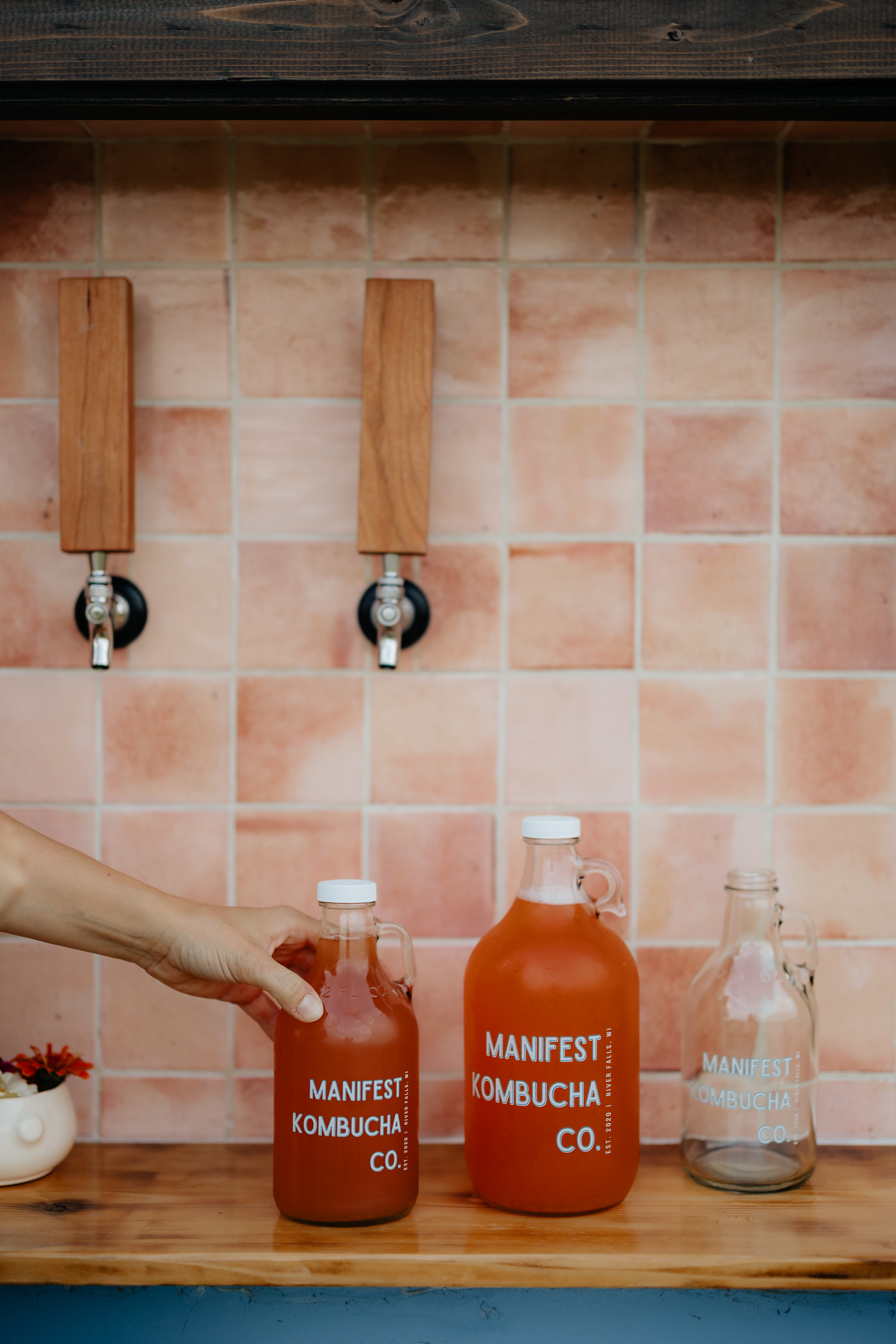 Manifest Kombucha growlers lined up at the trailer
